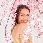 Woman in Spring Flowers Smiling