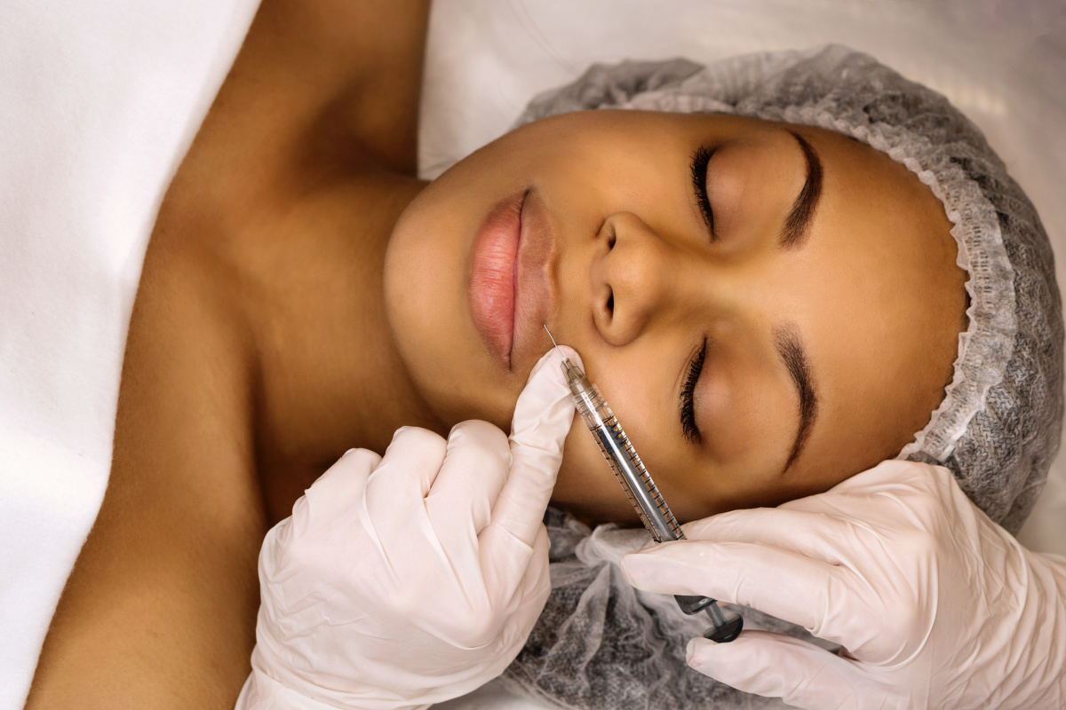 Woman getting lip filler injections at a medspa