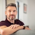 Mature man relaxing on couch at home