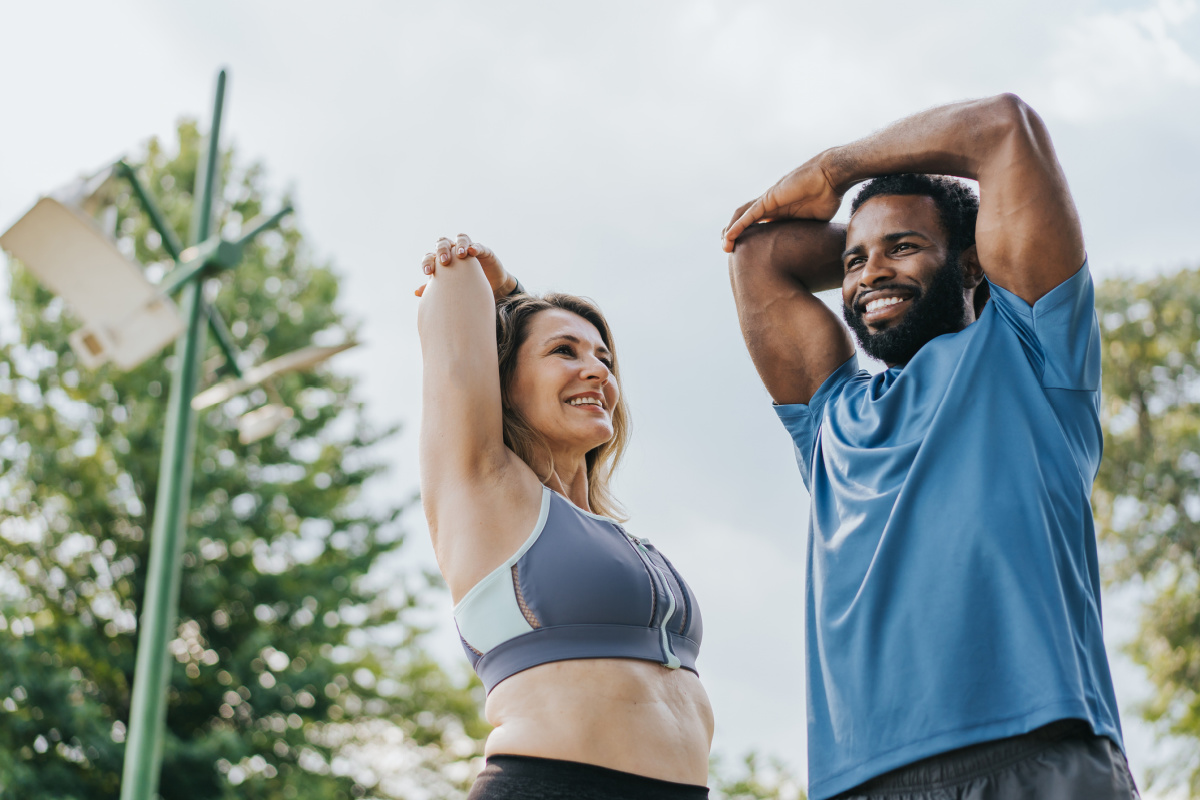 Mature man and woman stretching after daily workout